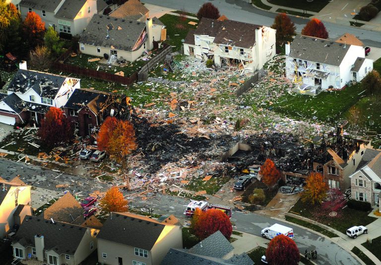 FILE - This aerial file photo from Nov. 11, 2012, shows the two homes that were leveled and the numerous neighboring homes that were damaged from a massive explosion that sparked a huge fire and killed two people in Indianapolis. Authorities launched a homicide investigation Monday, Nov. 19, 2012 into the house explosion that killed a young couple and left numerous homes uninhabitable in an Indianapolis neighborhood. (AP Photo/The Indianapolis Star, Matt Kryger, File) NO SALES