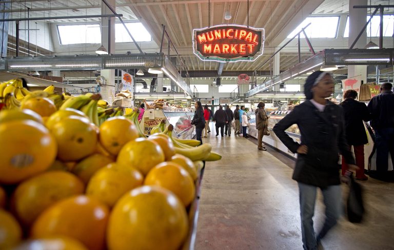 FILE - This Dec. 20, 2013, file photo shows shoppers passing through the Sweet Auburn Curb Market in Atlanta. Cuts to the nation's food stamp program enacted earlier this year are only affecting four states, far from the sweeping reform that Republicans had pushed, according to an Associated Press review. As a result, it's unclear if the law will realize the estimated $8.6 billion in savings over 10 years that the GOP had touted.  (AP Photo/David Goldman, File)