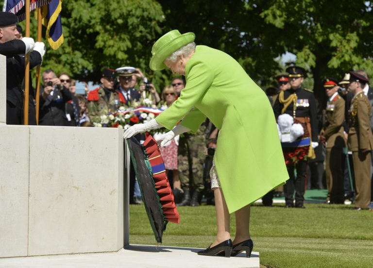 Britain's Queen Elizabeth lays a wreath during the French-British ceremony at the British War cemetery in Bayeux, Normandy, France, Friday, June 6, 2014. World leaders and veterans gathered by the beaches of Normandy on Friday to mark the 70th anniversary of World War Two's D-Day landings. (AP Photo/Thomas Bregardis, pool)