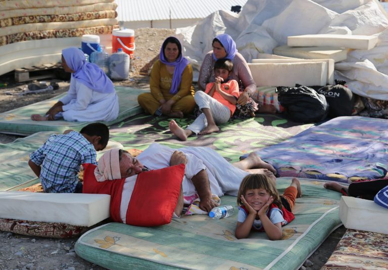 Displaced Iraqis from the Yazidi community settle at the Qandil mountains near the Turkish border outside Zakho, 300 miles (475 kilometers) northwest of Baghdad, Iraq, Saturday, Aug. 16, 2014. Islamic extremists shot 80 Yazidi men to death in Iraq, lining them up in small groups and opening fire with assault rifles before abducting their wives and children, officials and eyewitnesses reported Saturday. (AP Photo/ Khalid Mohammed)