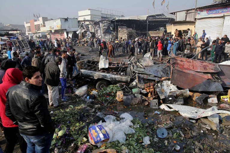 Citizens inspect the scene after a car bomb explosion at a crowded outdoor market in the Iraqi capital's eastern district of Sadr City, Iraq, Sunday, Jan 8, 2017. (AP Photo/ Karim Kadim)