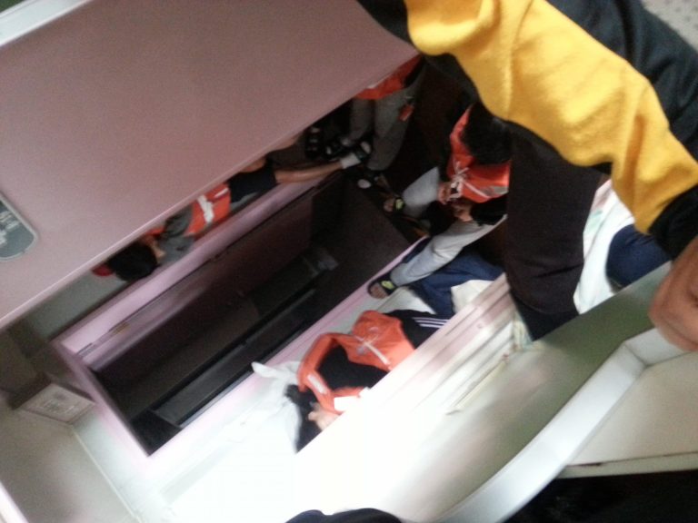 In this April 16, 2014 photo taken with a mobile phone by deceased South Korean high school student Park Su-hyeon and released by his father Park Jong-dae, students are shown inside the sinking ferry Sewol on waters near Jindo, South Korea. Soon after the ferry begins to tilt, nervous laughter can be heard from the high school students huddled below deck. In video clips from the cellphone of Park Su-hyeon, a victim of the disaster that has shaken South Korea, the teenagers talk of taking selfies, wonder if they'll make the news and discuss posting about the excitement later on Facebook. (AP Photo/Park Su-hyeon courtesy of the Park Family)