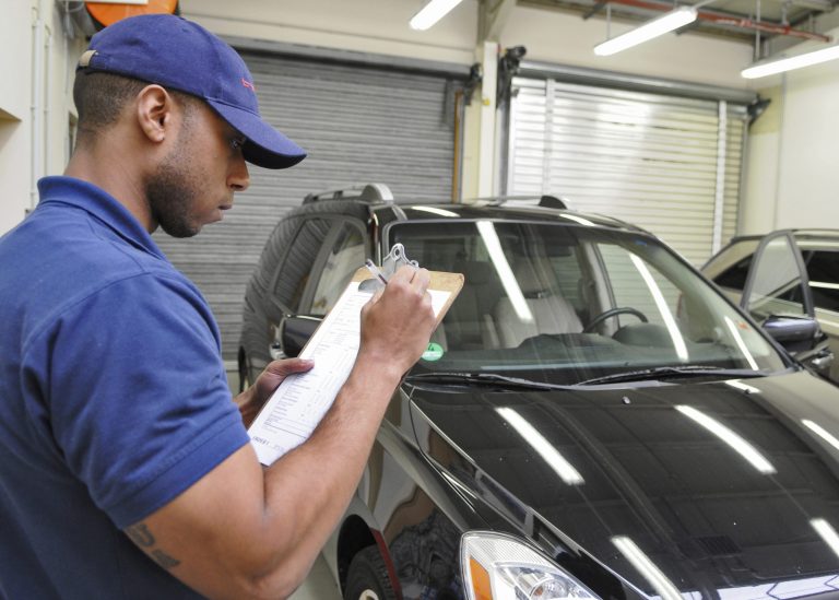 Halston Epps, a vehicle inspector with American Auto Logistics, inspects a U.S. Air Force airman's vehicle in a garage at Spangdahlem Air Base, Germany, in 2011. AAL lost the contract to move American military personnel's personal vehicles earlier this year, and some military families say its replacement, International Auto Logistics, isn't doing a good job. (Photo: U.S. Air Force/Senior Airman Nick Wilson)