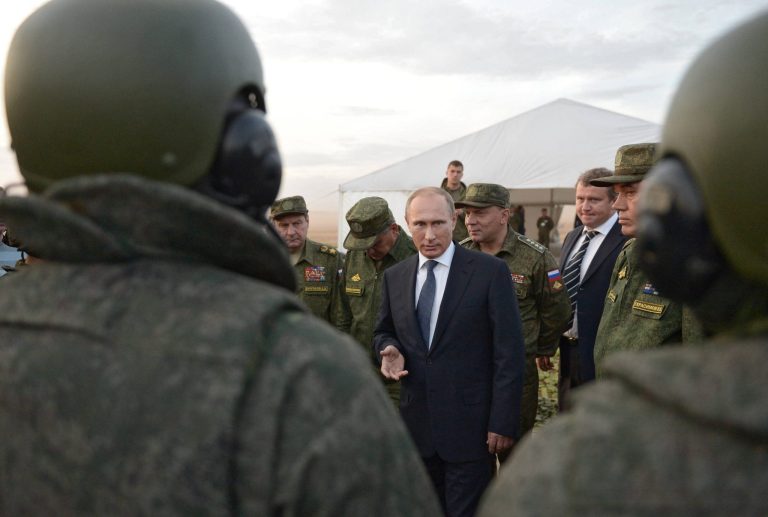 In this Saturday, Sept. 19, 2015 file pool photo, Russian President Vladimir Putin, center, meets with officers after military exercises at Donguz range in Orenburg region, Russia. In recent weeks, Moscow has expanded its presence in the country to the largest extent in more than 40 years.Â (Alexei Nikolsky/RIA-Novosti, Kremlin Pool Photo via AP, file)