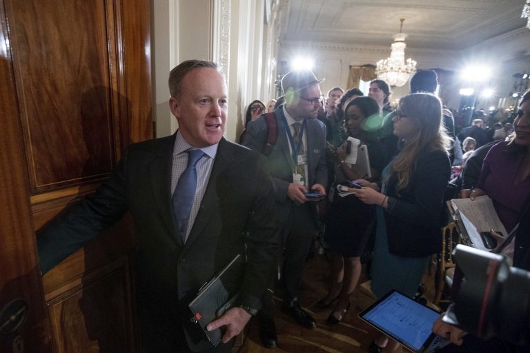 White House press secretary Sean Spicer, left, departs following a news conference with President Donald Trump and Italian Prime Minister Paolo Gentiloni in the East Room of the White House in Washington, Thursday, April 20, 2017. (AP Photo/Andrew Harnik)