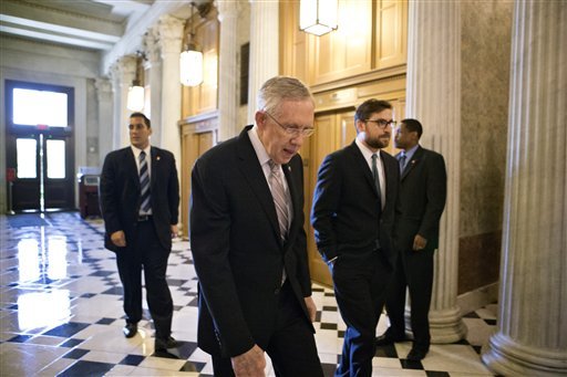 Senate Majority Leader Harry Reid, D-Nev., makes his way to the floor of the Senate to introduce a resolution to authorize military action to support President Barack Obama's request for a strike against Syria, at the Capitol in Washington, Friday, Sept. 6, 2013.  (AP Photo/J. Scott Applewhite)