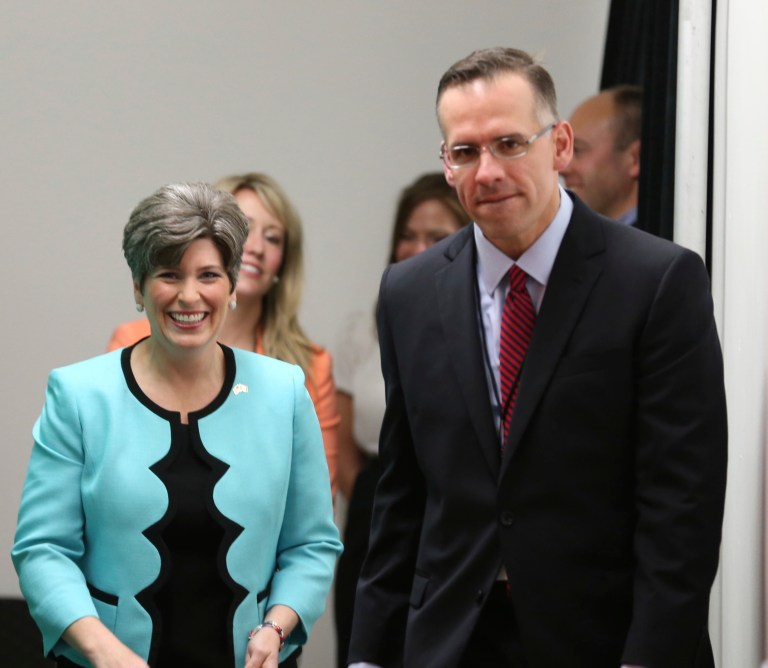 Joni Ernst and her husband Gail walk down a hall before taking the stage during a primary election night party on June 3, at the Des Moines Social Club in downtown Des Moines, Iowa. (AP Photo/The Des Moines Register, Charlie Litchfield)