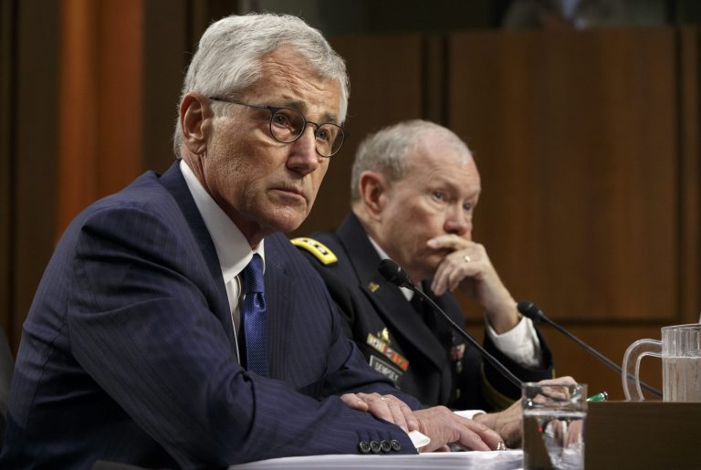 Defense Secretary Chuck Hagel, left, and Army Gen. Martin Dempsey, chairman of the Joint Chiefs of Staff, appear before the Senate Armed Services Committee, the first in a series of high-profile Capitol Hill hearings that will measure the president's ability to rally congressional support for President Barack Obama's strategy to combat Islamic State extremists in Iraq and Syria, in Washington, Tuesday, Sept. 16, 2014. Obama last week outlined his military plan to destroy the extremists, authorizing U.S. airstrikes inside Syria, stepping up attacks in Iraq and deploying additional American troops, with more than 1,000 now advising and assisting Iraqi security forces to counter the terrorism threat.  (AP Photo/J. Scott Applewhite)