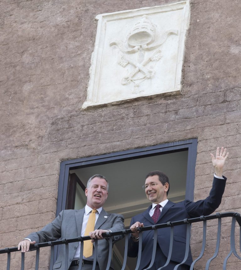 New York City Mayor Bill de Blasio, left, and Rome Mayor Ignazio Marino wave from a balcony of Rome's Campidoglio, Capitol Hill, overlooking the Roman Forum and Colosseum, Sunday, July 20, 2014. De Blasio and his family are in Italy for a family vacation. (AP Photo/Alessandra Tarantino)
