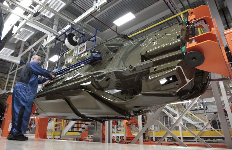 FILE In this March 14, 2014 file photo, an assembly line worker works on a 2015 Chrysler 200 automobile at the Sterling Heights Assembly Plant in Sterling Heights, Mich.  The Commerce Department releases its report on orders to U.S. factories for July on Wednesday, Sept. 3, 2014.(AP Photo/Paul Sancya)