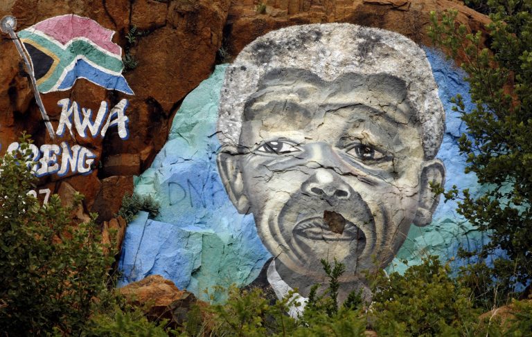   A mural depicts South African President Nelson Mandela on a hill in Soweto, South Africa, Wednesday, Dec. 12, 2012. South Africa's former President Nelson Mandela 