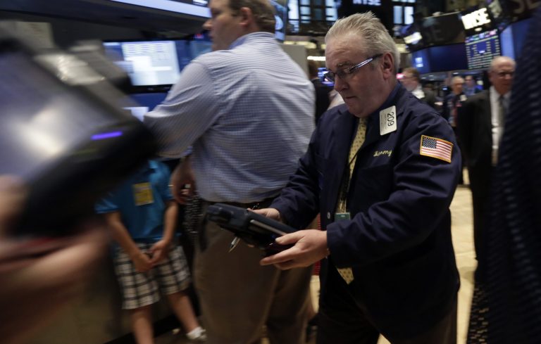 Trader James Dresch, right, works on the floor of the New York Stock Exchange, Monday, June 30, 2014.  European stocks were lower Wednesday July 30, 2014 ahead of U.S. economic data while cheery earnings from major Japanese companies such as Honda Motor Co. boosted Asian markets.(AP Photo/Richard Drew)