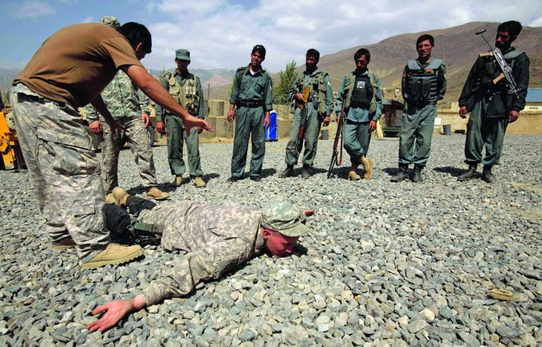 FILE - In this Saturday, Sept. 19, 2009 file photo, U.S. Army Sgt. William Womack, 23, from Batesville, Ga., of the 118th Military Police Co., based at Fort Bragg, N.C., is prone during a training session for the Afghan National Police at a combat outpost in the Jalrez Valley in Afghanistan's Wardak Province. Hundreds of soldiers have been detained or removed from the Afghan National Army in 2012 after a surge in insider attacks against foreign forces who are their supposed partners in the fight against Taliban insurgents and other militants. The Afghan officials say they are re-vetting soldiers to stem the attacks that threaten to unravel the international community's alliance with the fragile government trying to stand on its own as foreign troops withdraw.(AP Photo/Maya Alleruzzo, File)