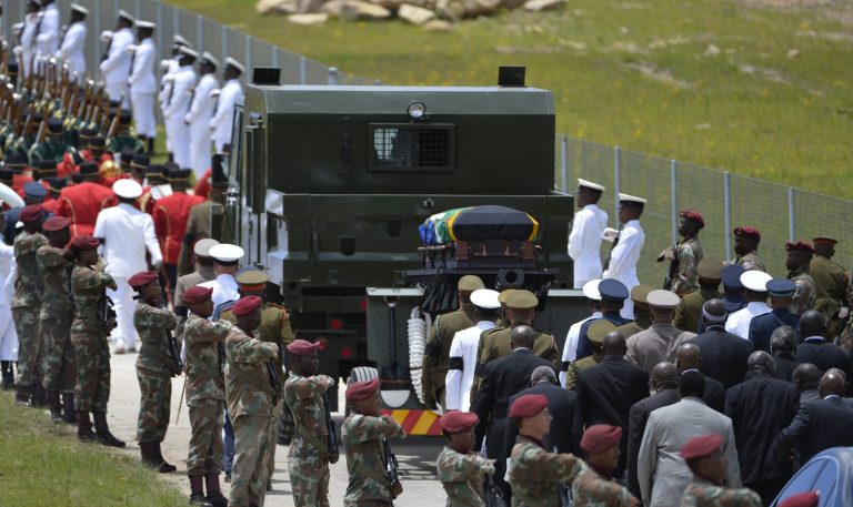 Former South African President Nelson Mandela's casket is take by military gun carriage to his burial place following his funeral service in Qunu, South Africa, Sunday, Dec. 15, 2013. (AP Photo/Odd Andersen, Pool)