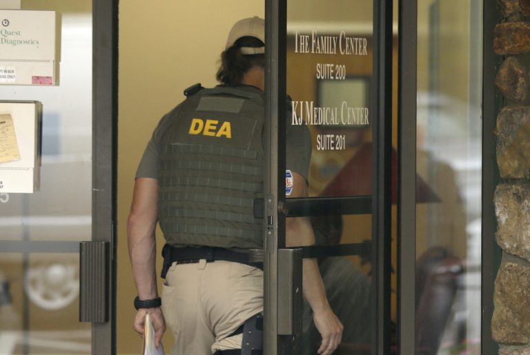 A Drug Enforcement Administration officer walks into a medical clinic in Little Rock, Ark., Wednesday, May 20, 2015.Â The DEAÂ is involved in a lawsuit for targeting medical records using judge-less warrants called 