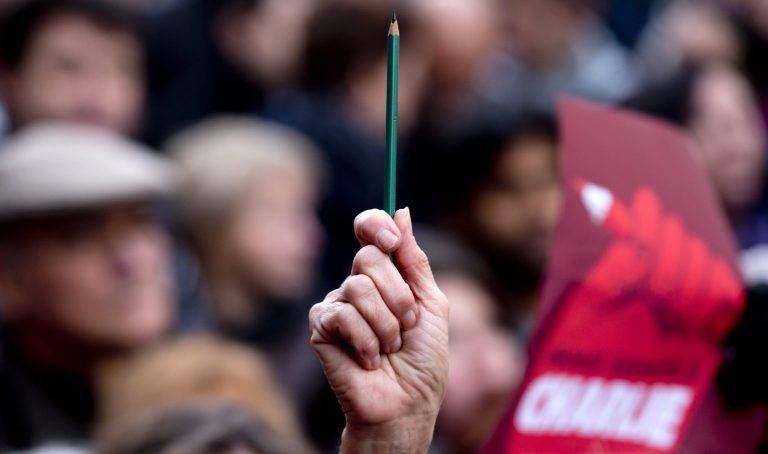 A demonstrator holds a pencil during a demonstration in Paris, France, Sunday, Jan. 11, 2015. (AP Photo / Peter Dejong)