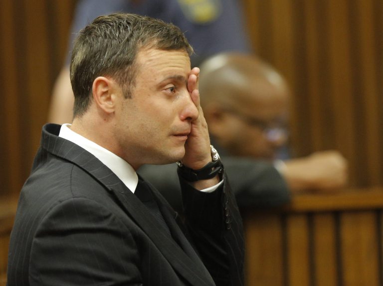 Oscar Pistorius cries in the dock in Pretoria, South Africa, Thursday, Sept. 11, 2014 as Judge Thokozile Masipa reads notes as she delivers her verdict in Pistorius' murder trial. The verdict is expected to take hours and possibly two days to present. She will decide with the help of two legal assessors if Pistorius is guilty of the murder of his girlfriend Reeva Steenkamp. (AP Photo/Kim Ludbrook, Pool)