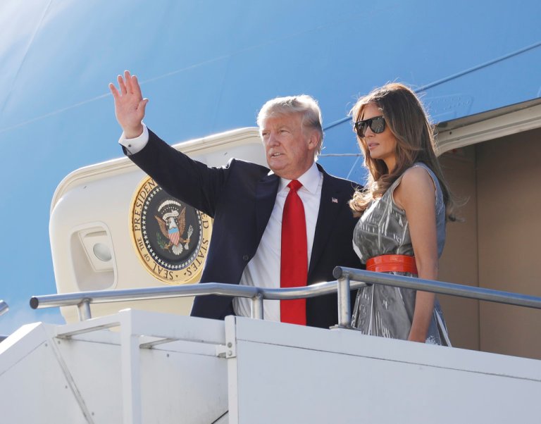 President Donald Trump, accompanied by first lady Melania Trump, waves as they board Air Force One in Hamburg, Germany, Saturday, July 8, 2017, following the G20 Summit. (AP Photo/Evan Vucci)