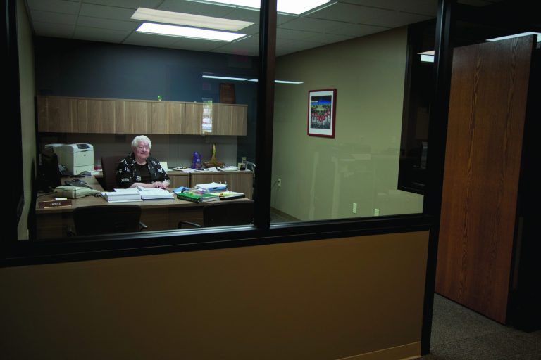 In this photo taken Aug. 1, 2012, Janice Durflinger poses for a photo at her workplace in Lincoln, Neb. Durflinger, who runs computer software programs for a bank, says she still works at 76, 