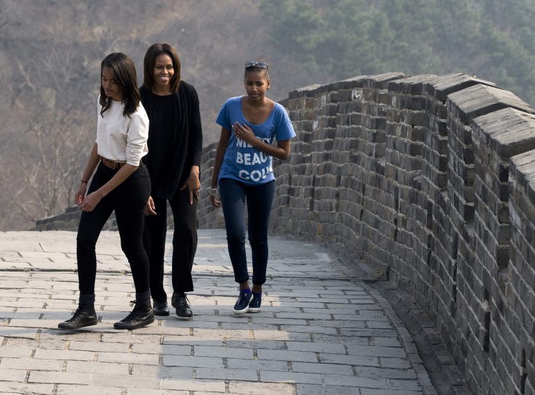 U.S. first lady Michelle Obama walks with her daughters Malia, left, and Sasha, right, as they visit the Mutianyu section of the Great Wall of China in Beijing Sunday, March 23, 2014. (AP Photo/Andy Wong)