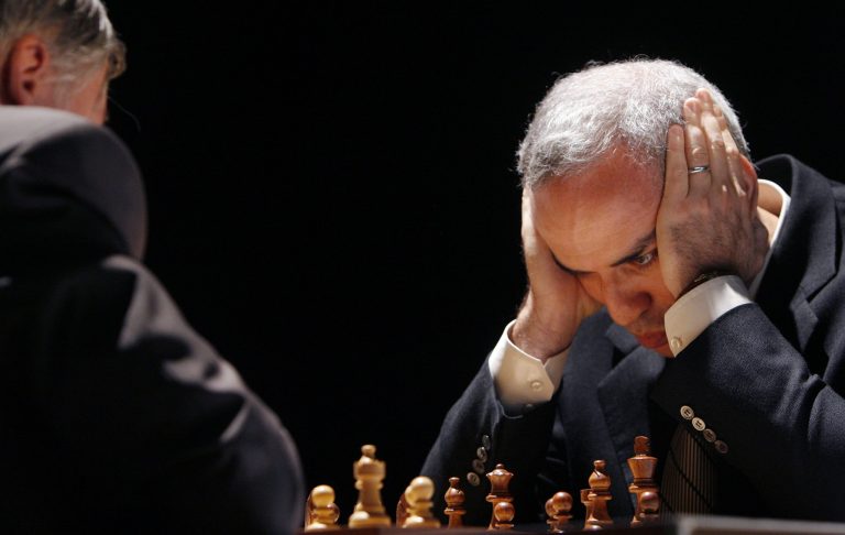 FILE - In this Tuesday, Sept. 22, 2009 file photo, former chess world champion Garry Kasparov, right, and Anatoly Karpov, left, play an exhibition rematch in Valencia, Spain. Kasparov is hoping to oust the head of the World Chess Federation in a bitter contest on the sidelines of an international tournament in Norway. Kasparov, a vocal critic of Russian President Vladimir Putin, is challenging Kirsan Ilyumzhinov, a wealthy businessman known to be supported by the Russian president. (AP Photo/Alberto Saiz, File)