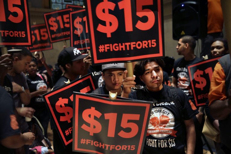 Demonstrators rally for a $15 minimum wage before a meeting of the wage board in New York, Monday, June 15, 2015. (AP Photo/Seth Wenig)