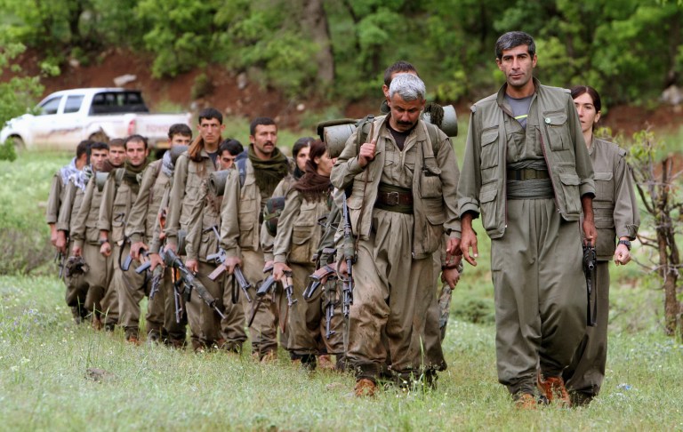 A group of armed Kurdish fighters from the Kurdistan Workers Party (PKK) enter northern Iraq in the Heror area, northeast of Dahuk, 260 miles (430 kilometers) northwest of Baghdad, Tuesday, May 14, 2013. The first of Kurdish fighters from Turkey have entered northern Iraq as part of a peace deal to end a long uprising, despite Iraqi objections to the transfer. Comrades greeted 13 armed men and women from the Kurdistan Workers Party (PKK) at a ceremony in Heror in Iraq's self-ruled Kurdish area. The central government in Baghdad has rejected the deal, warning that the entry of more armed Kurdish fighters could harm the country's security. (AP Photo/ Ceerwan Aziz)