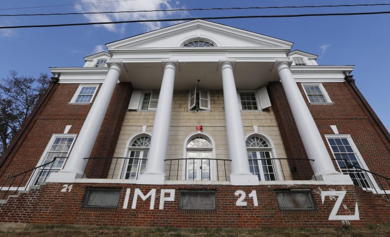 Three University of Virginia graduates and members of the fraternity profiled in a debunked account of a gang rape in a retracted Rolling Stone magazine story filed a lawsuit against the publication and the article's author Wednesday. (AP Photo/Steve Helber)