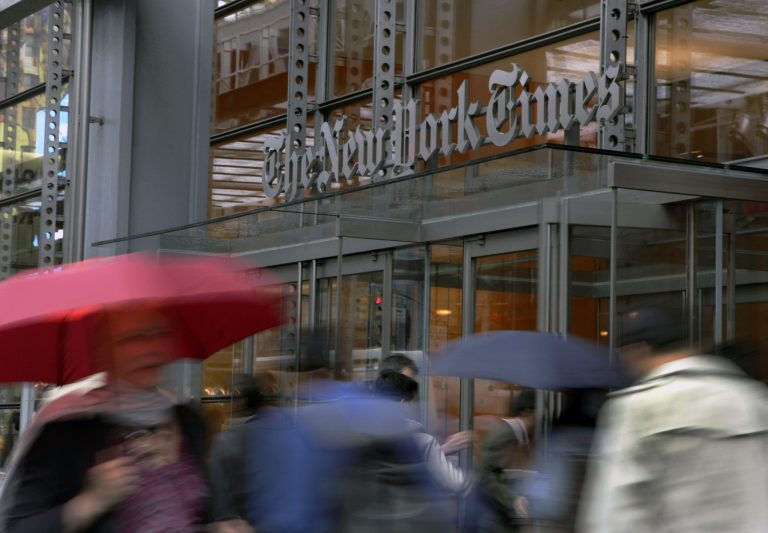 People pass the New York Times building in New York. (AP/Richard Drew)