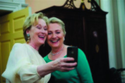 Actress Meryl Streep uses her iPhone to get a photo of her and Secretary of State Hillary Rodham Clinton following the State Department Dinner for the Kennedy Center Honors gala at the State Department in Washington. (AP Photo/Kevin Wolf)