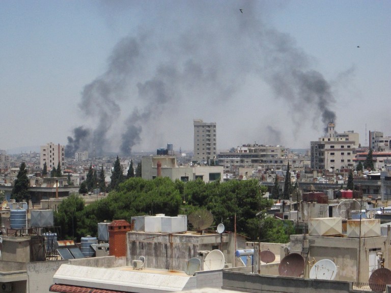   In this image made available on Tuesday June 12, 2012 smoke rises from a residential area of Talbisah in Homs city Syria Saturday June 9, 2012. (AP Photo/David Manyua/United Nations )  