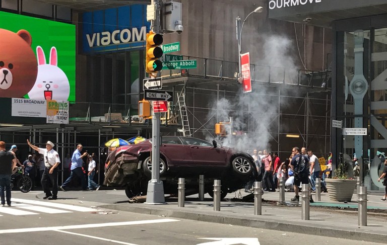 Photos from the scene show a maroon car lodged between barriers along a sidewalk in the tourist destination. (Photo courtesy: @gb_/Twitter)
