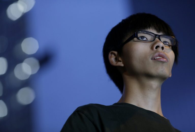 Joshua Wong, 17-year old student leader, stands on the stage during a rally in the occupied areas at Central district in Hong Kong, Thursday, Oct. 9, 2014. A Hong Kong government official canceled planned talks with student protest leaders on Friday, saying they were unlikely to be constructive. (AP Photo/Vincent Yu)