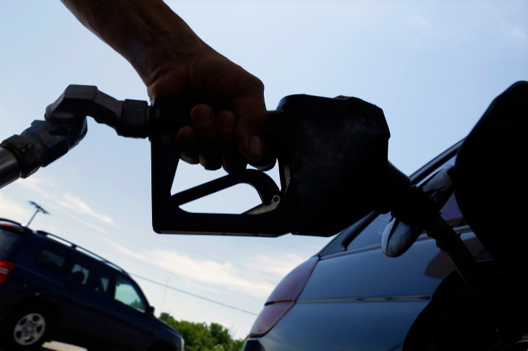 Fuel-efficiency rules mean cars that use higher-priced, premium gasoline, the Energy Department's data arm says. (AP Photo/Seth Perlman)