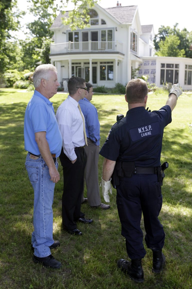   Law enforcement officers search the home of Dr. Timothy Jorden in Hamburg, N.Y., Thursday, June 14, 2012. Jorden is sought in connection with the hospital shooting death of his ex-girlfriend at Erie County Medical Center in Buffalo, N.Y. on Wednesday. (AP Photo/David Duprey)  