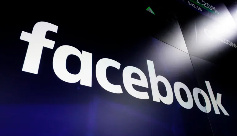 A list of settlements, violations and breaches scrolls over Facebook's logo on a screen as David Marcus, CEO of Facebook's Calibra digital wallet service, foreground, appears before a House Financial Services Committee hearing on Facebook's proposed cryptocurrency on Capitol Hill in Washington, Wednesday, July 17, 2019.