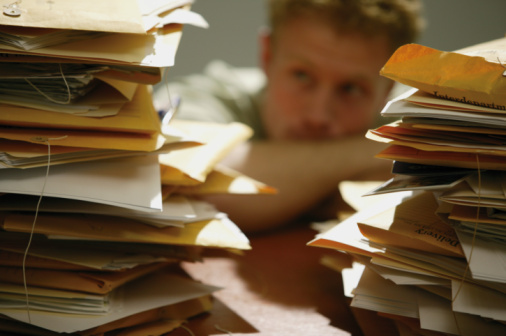 Man with piles of paperwork