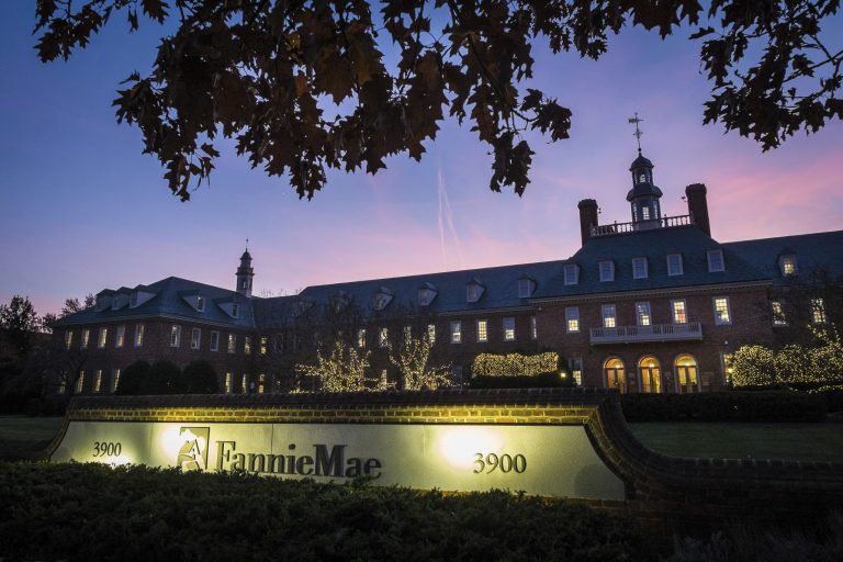 The sun sets behind the Fannie Mae headquarters in Washignton. (AP/J. David Ake)