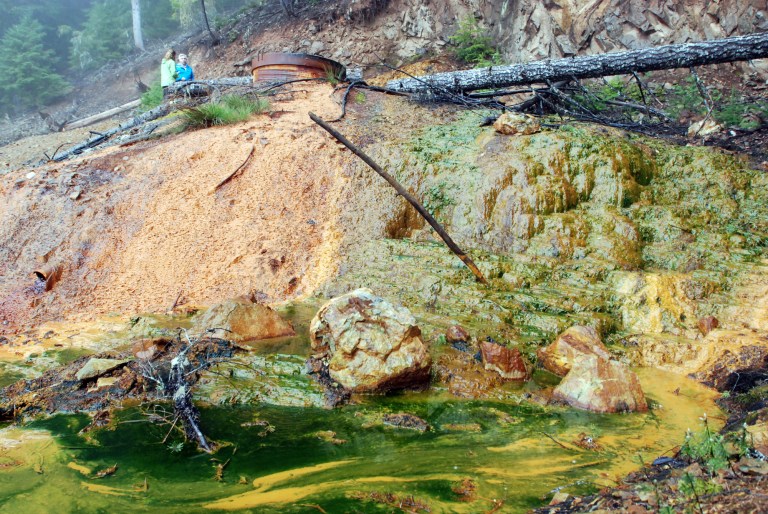 Algae grows in a pool of acidic water flowing out of the abandoned Formosa Mine a Superfund site located outside Riddle, Ore., on Thursday, April 17, 2014. The Canadian developers of the mine posted a bond of $900,000 for cleanup efforts before walking away from the mine, but cleanup efforts funded by taxpayers are estiamted to cost more than $20 million.