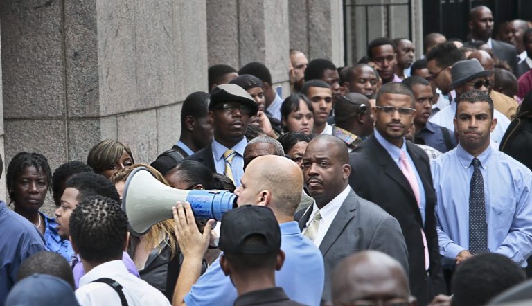   FILE - In this Thursday, Aug. 8, 2013, file photo, Applicants listen to a speaker's bull horn instructions for attending a combined Metropolitan Transportation Authority (MTA) and Harlem Week job and career fair at Columbia University in New York. The Labor Department reports the number of Americans who applied for unemployment benefits for the second week of September on Thursday, Sept. 12, 2013. (AP Photo/Bebeto Matthews, File)  