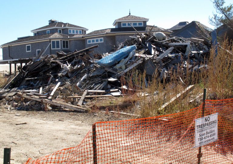 FILE - In this Oct. 15, 2013, file photo, a fence closes off the ruins of an oceanfront home in Mantoloking N.J.  that was damaged by Superstorm Sandy. The House is pressing ahead with legislation to roll back a recently enacted overhaul of the federal flood insurance program after homeowners in flood-prone areas complained about sharp premium increases. (AP Photo/Wayne Parry, File)