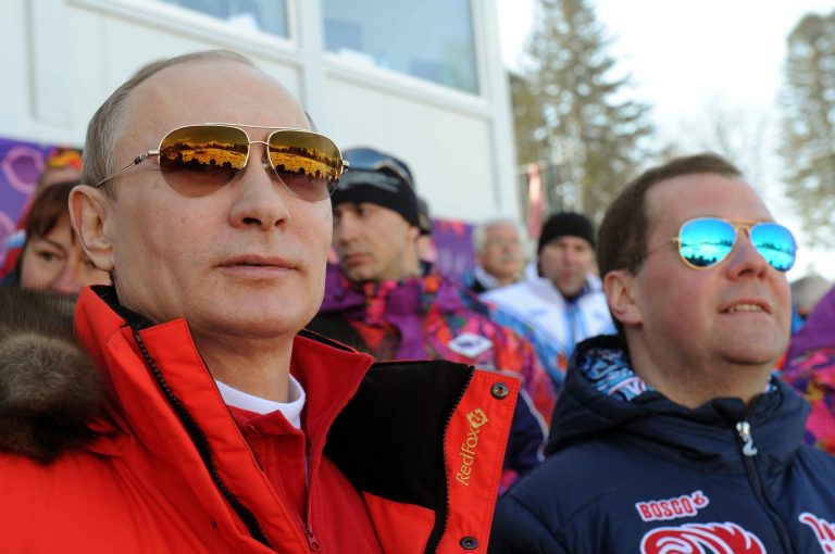 FILE - In this Feb. 16, 2014 file photo, Russian President Vladimir Putin, left, and Premier Dmitry Medvedev watch the men's 4x10 km cross-country relay at the 2014 Winter Olympics in Krasnaya Polyana, Russia. Competitors at the Olympics get nervous knowing that the eyes of the world will be on them for a few minutes. For Putin, that scrutiny extends for the entire 17 days of the games. (AP Photo/RIA-Novosti, Mikhail Klimentyev, Presidential Press Service)