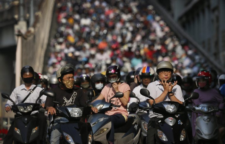 A motorist, right, practices Chinese meditation as he waits at a traffic light with thousands commuting on scooters into Taipei, Taiwan, Thursday morning, Sept. 4, 2014. According to 2012 statistics from the Directorate-General of Budget, Accounting and Statistics (DGBAS), nationwide scooter usage last year stood at 48.5 percent, roughly 12 million people. (AP Photo/Wally Santana)