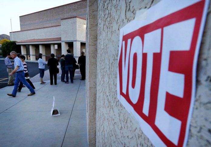 Some Arizona voters waited in line for hours after polls officially closed on Tuesday. (AP Photo/Matt York)