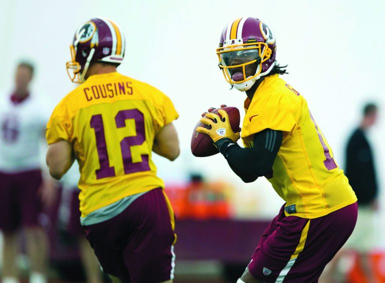 Evan Vucci/AP
Redskins rookie quarterback Robert Griffin III signed a four-year contract worth $21 million on Wednesday.
