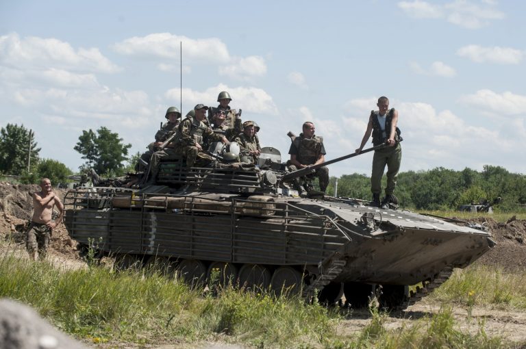 Ukrainian troops atop an APC at a checkpoint near Slovyansk, eastern Ukraine, Saturday, July 5, 2014. Ukraine's forces claimed a significant success against pro-Russian insurgents on Saturday, chasing them from one of their strongholds in the embattled east of the country. Rebels fleeing from the city of Slovyansk vowed to regroup elsewhere and fight on. (AP Photo/Evgeniy Maloletka)