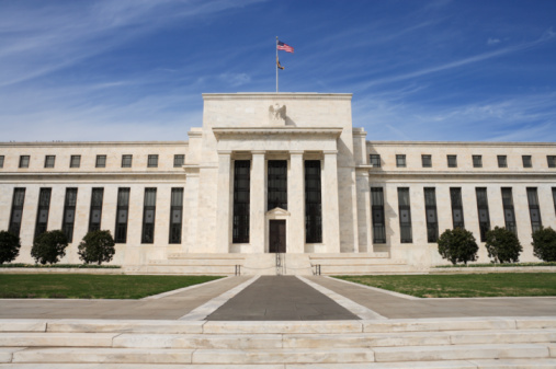 FILE - This Sept. 18, 2013 file photo shows the Federal Reserve headquarters in Washington. Minutes of the Fed's discussion at its July 29-30, 2014 meeting show that some officials thought the economy was improving enough that the Fed would need "to call for a relatively prompt move" toward reducing the support it has been providing. Otherwise, they felt the Fed risked overshooting its targets for unemployment and inflation. 
