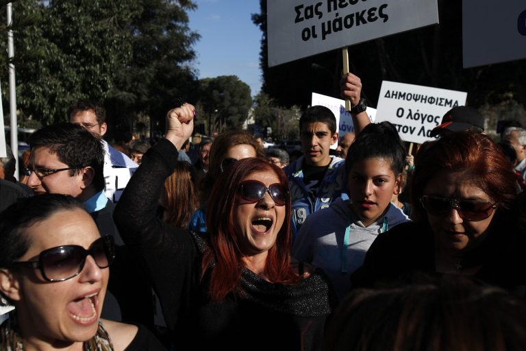 Protesters shout slogans during a protest outside of the parliament in Nicosia, Cyprus, Monday, March 18, 2013. A vote on a bailout package for Cyprus that includes an immediate tax on all savings accounts has been postponed until Tuesday evening. Yiannakis Omirou, the speaker of Parliament, said the delay was needed to give the government time to amend the deal reached over the weekend that prompted an outcry from those who thought their money was safe. In order to get euro 10 billion ($13 billion) in bailout loans from international creditors, Cyprus agreed to take a percentage of all deposits -- including ordinary citizens' savings -- an unprecedented step in Europe's 3 ?-year debt crisis. (AP Photo/Petros Karadjias)