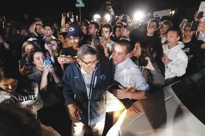 Matt Rourke/AP
A large crowd gathered outside of Joe Paterno's home to show support of the longtime Penn State coach as the 84-year-old's future with the Nittany Lions remains uncertain.