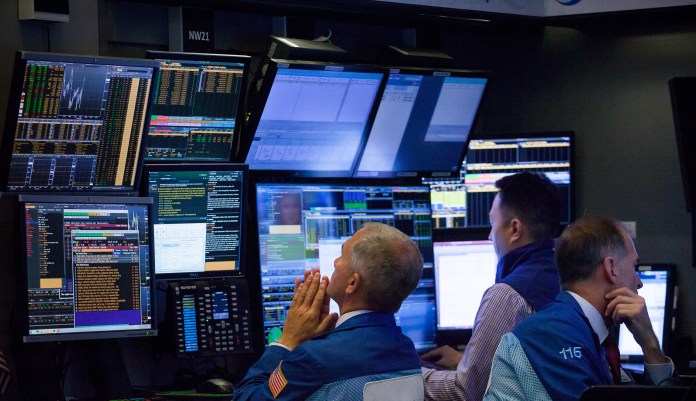 Traders work on the floor of the New York Stock Exchange (NYSE) in New York, U.S., on Monday, Aug. 20, 2018.